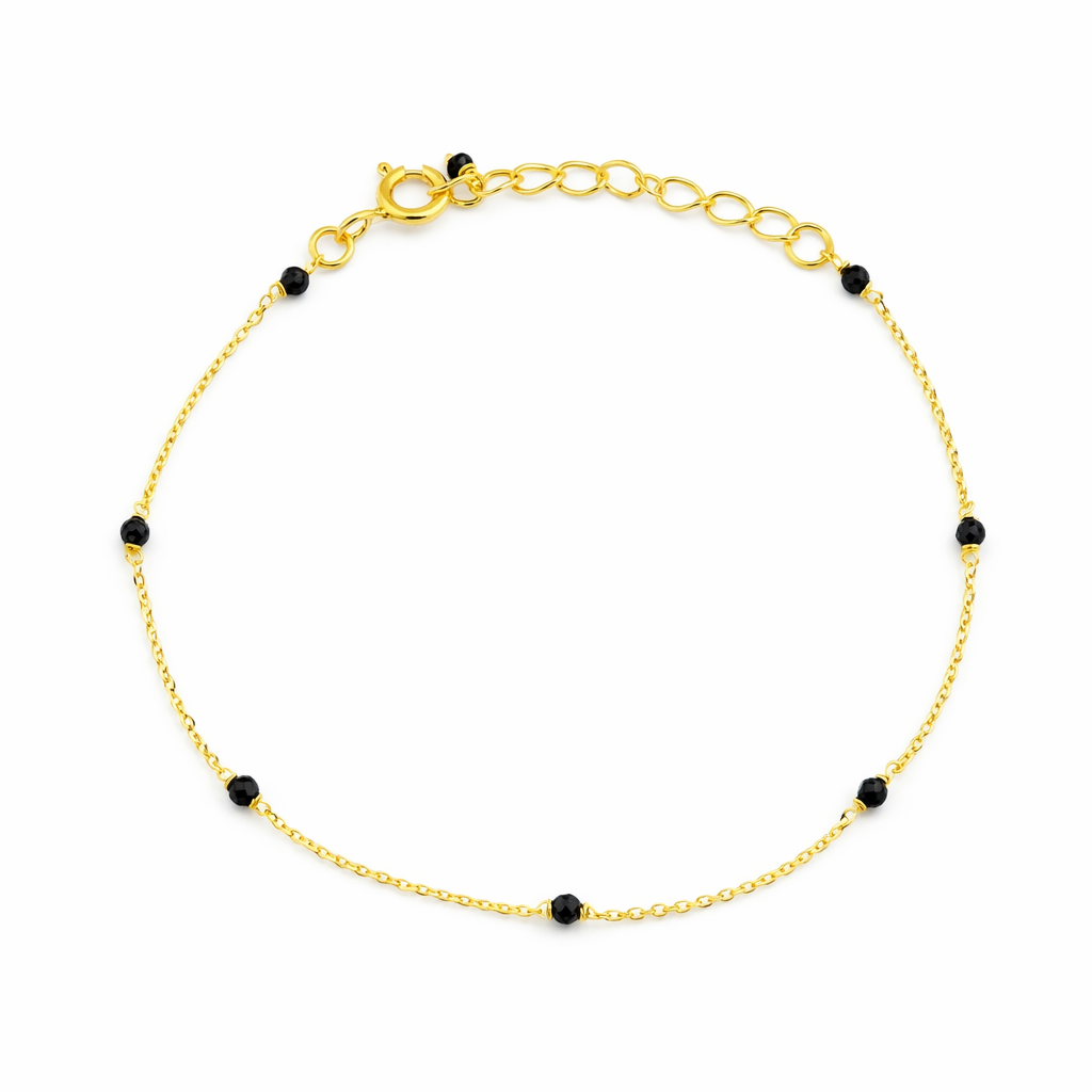 Black spinel station bracelet in gold